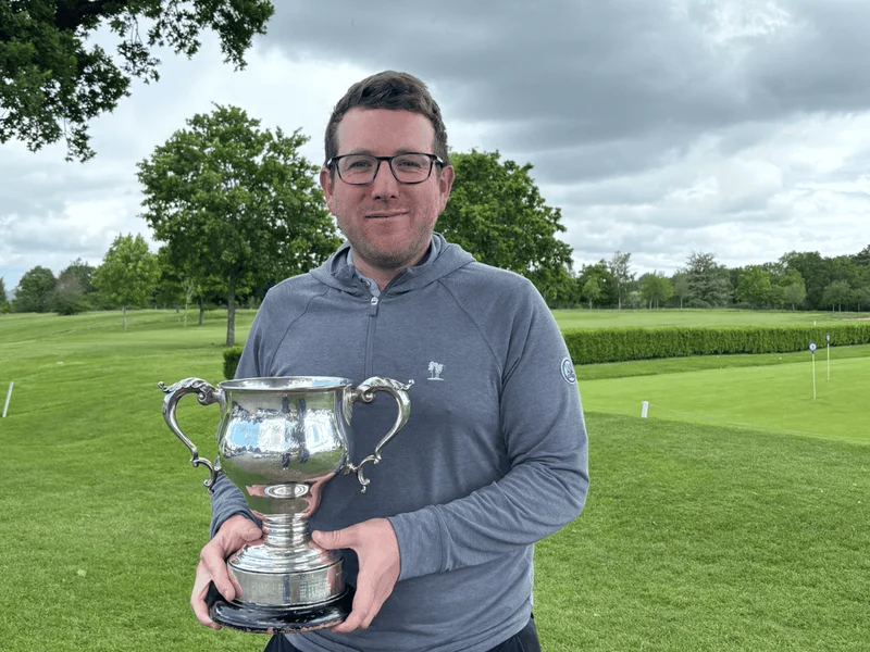 Michael lifts the trophy